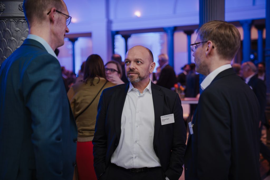 Roland Haun in discussion at a railway industry event
